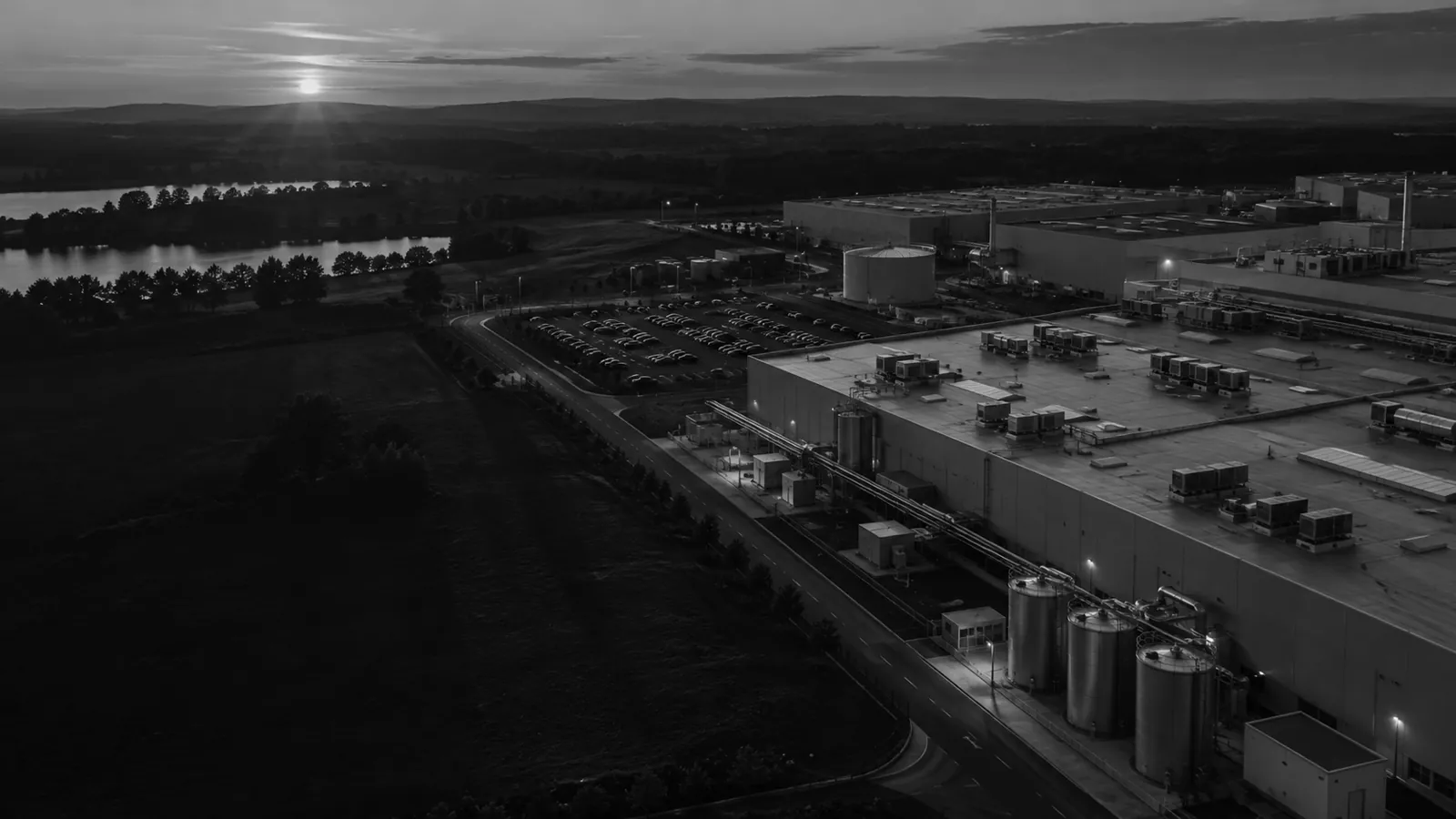 A manufacturing campus seen from the air at dusk